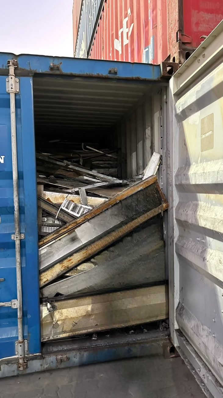 Container doors open showing graded metal scrap loaded inside